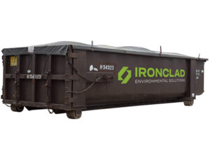 Roll off bin with tarp for storing solids.