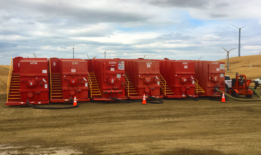Frac tanks on rent, manifolded together and connected to a rental pump. 