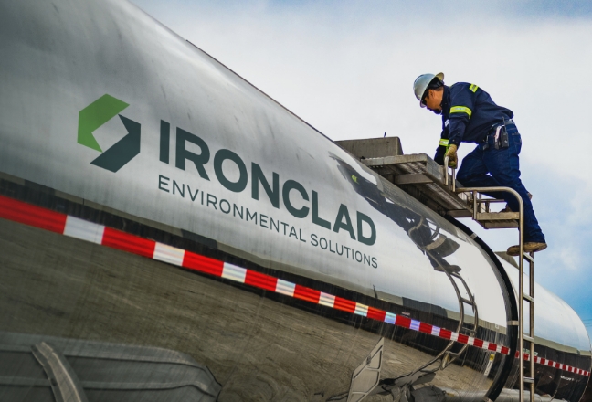 Ironclad employee inspecting tanker trailer before customer waste transport.