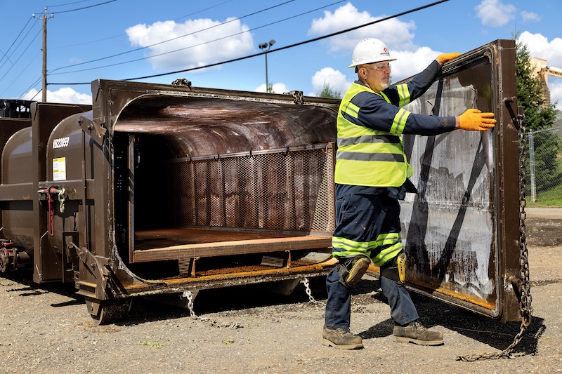 ironclad employee opening a dewatering tank