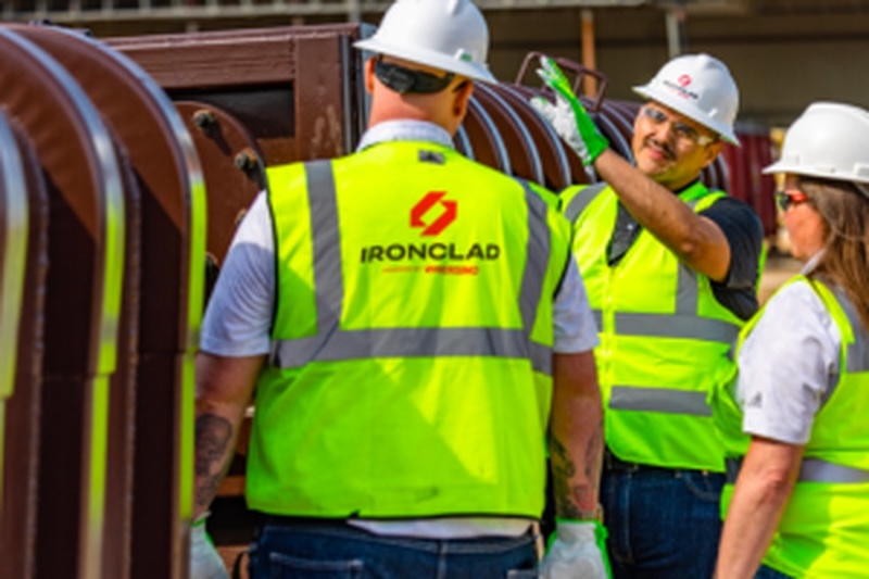 ironclad employee gesturing to the jobsite for two other employees